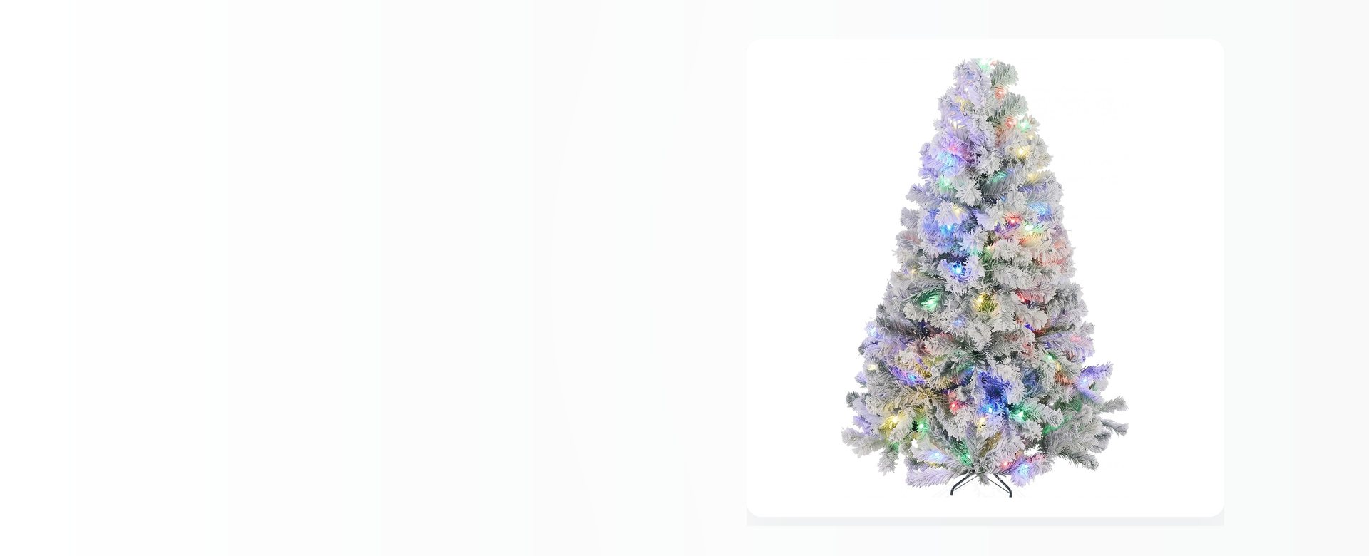 A pre-lit flocked Christmas tree photographed on a pale studio background.